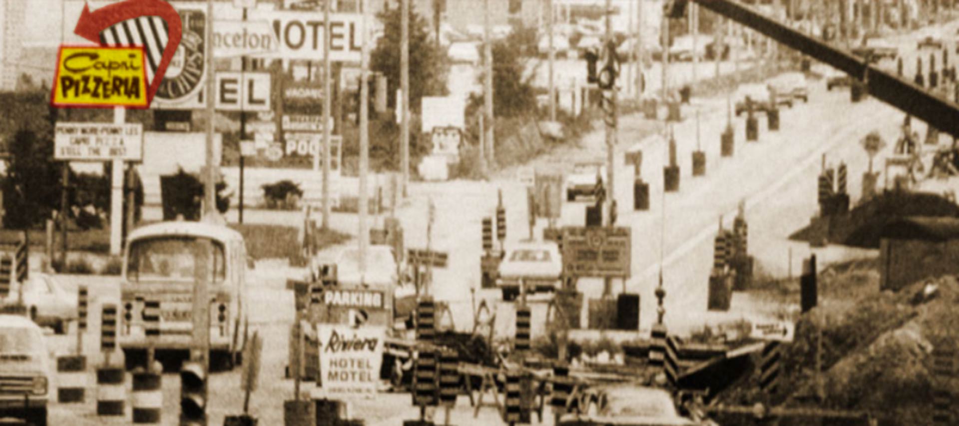 Dougall Road being widened to two lanes around 1960, with the original Capri sign at the left of the photo.